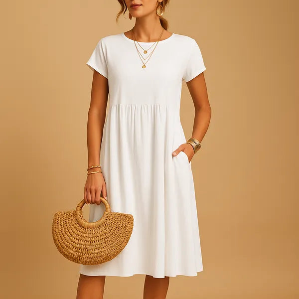 White Short Sleeve Babydoll Dress front view with gathered waist and side pockets