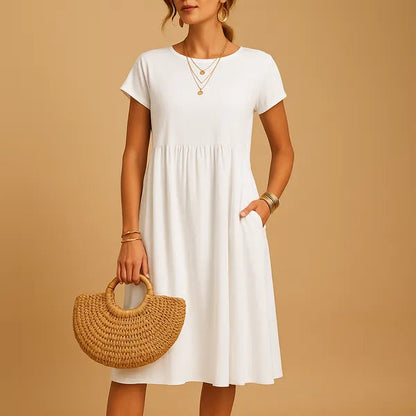 White Short Sleeve Babydoll Dress front view with gathered waist and side pockets