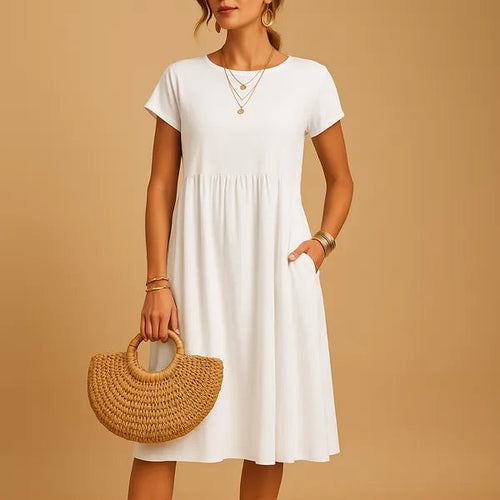 White Short Sleeve Babydoll Dress front view with gathered waist and side pockets