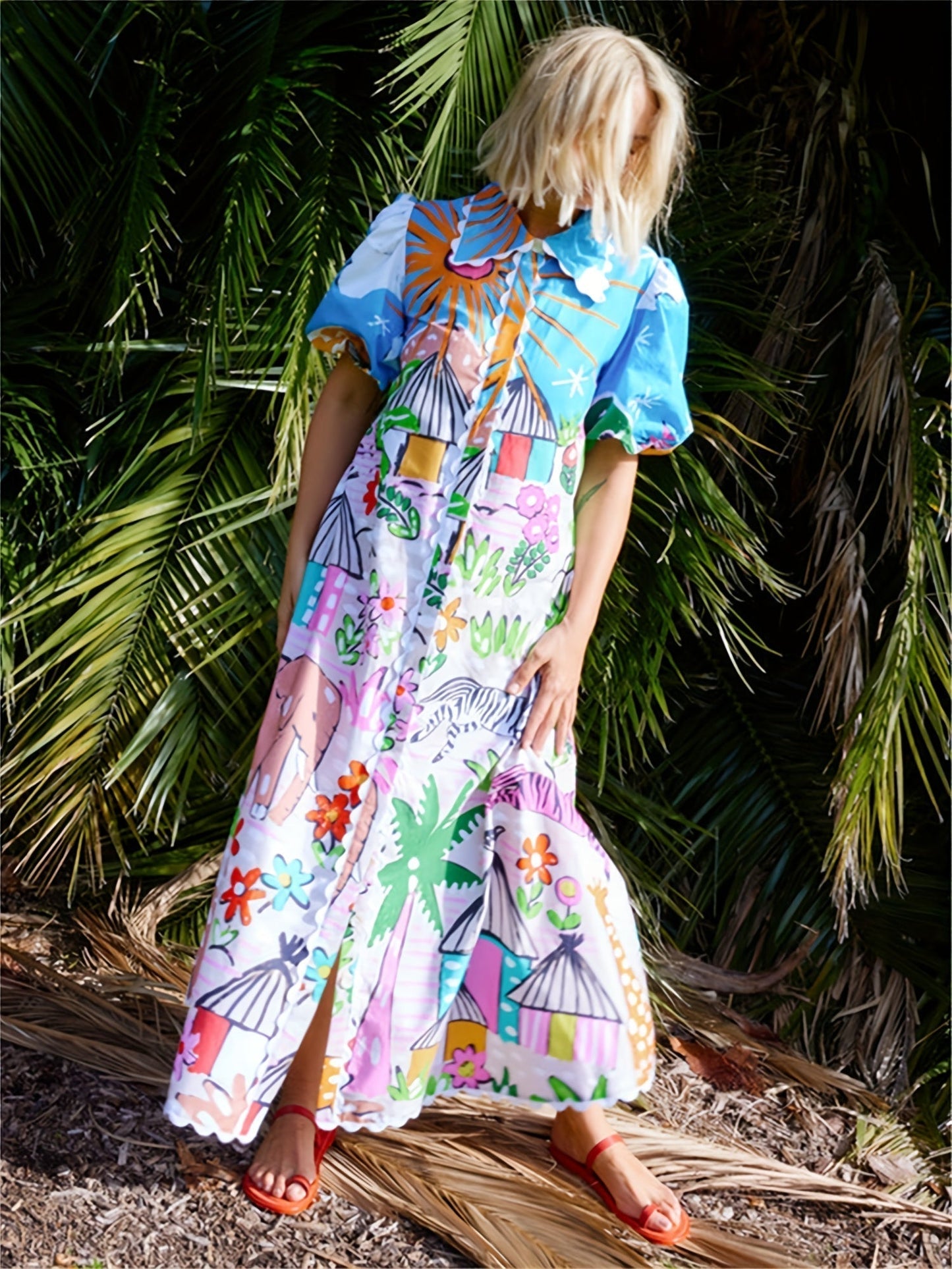 Marjolaine printed shirt maxi dress seen from the side among palm leaves