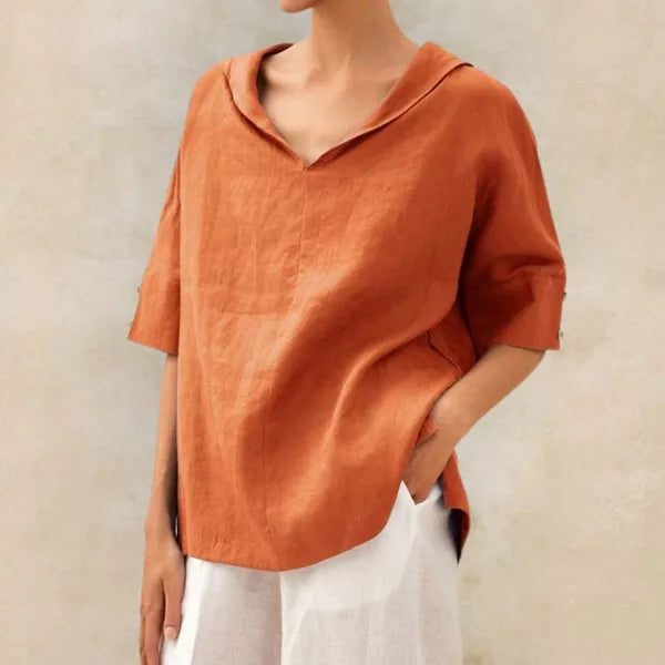 Women's Short Sleeve V Neck Blouse in Orange, front view with white trousers – Soraya