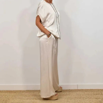 Anamaria white satin top and wide leg trousers set, side profile on model