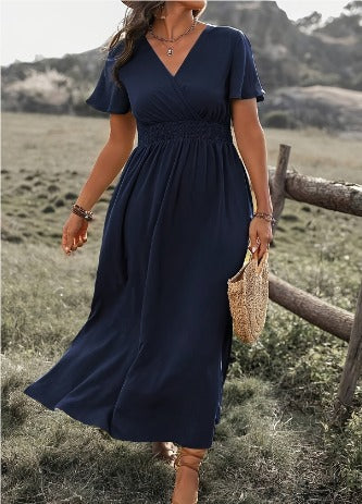 Kaia short sleeve wrap maxi dress in navy blue, front view in a field