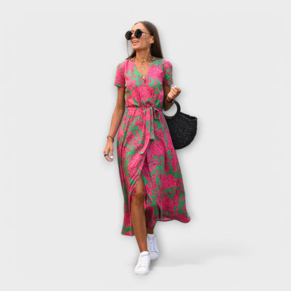 Mariz women's pleated midi dress in green and pink print, walking front view