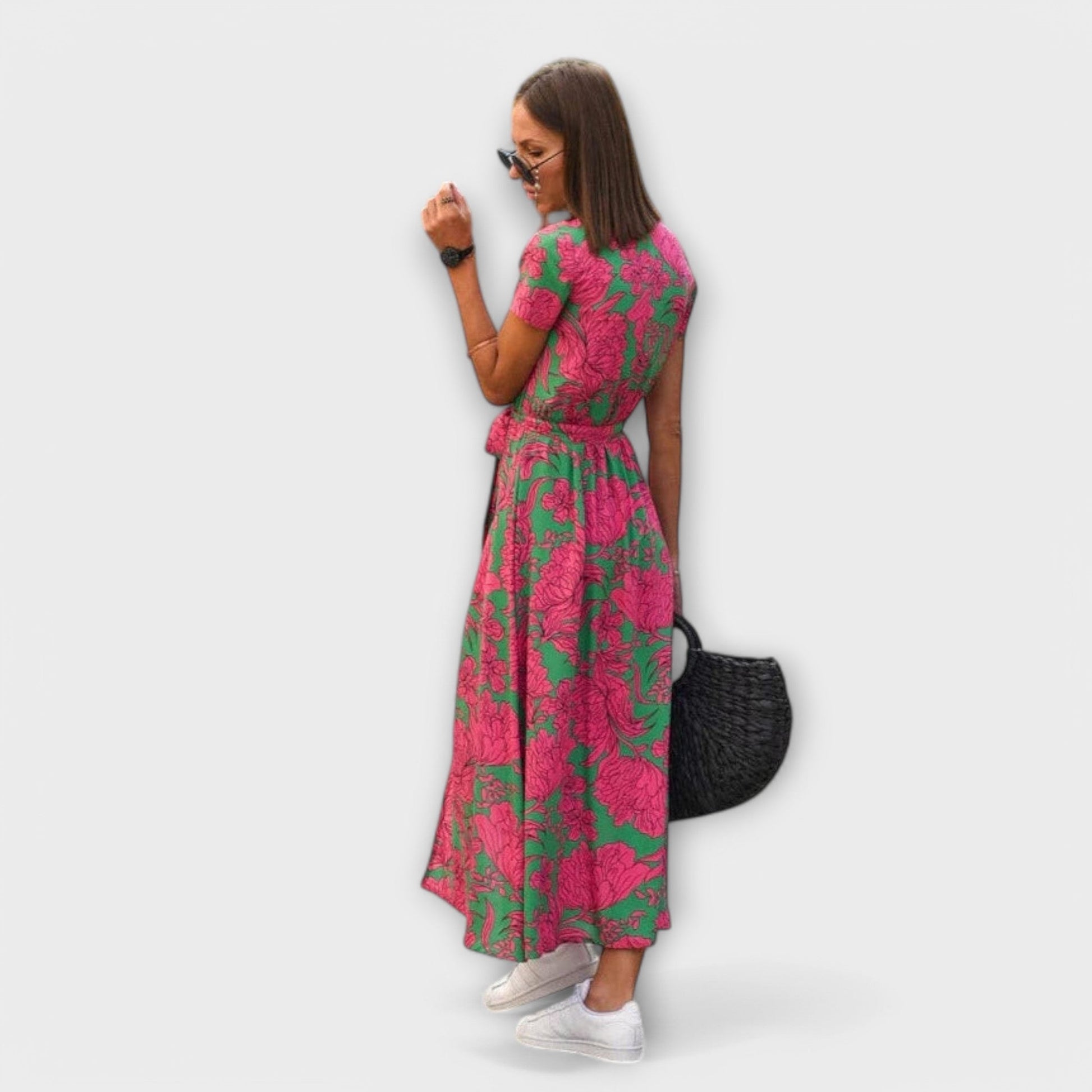 Mariz women's pleated midi dress in green and pink print, side view on model