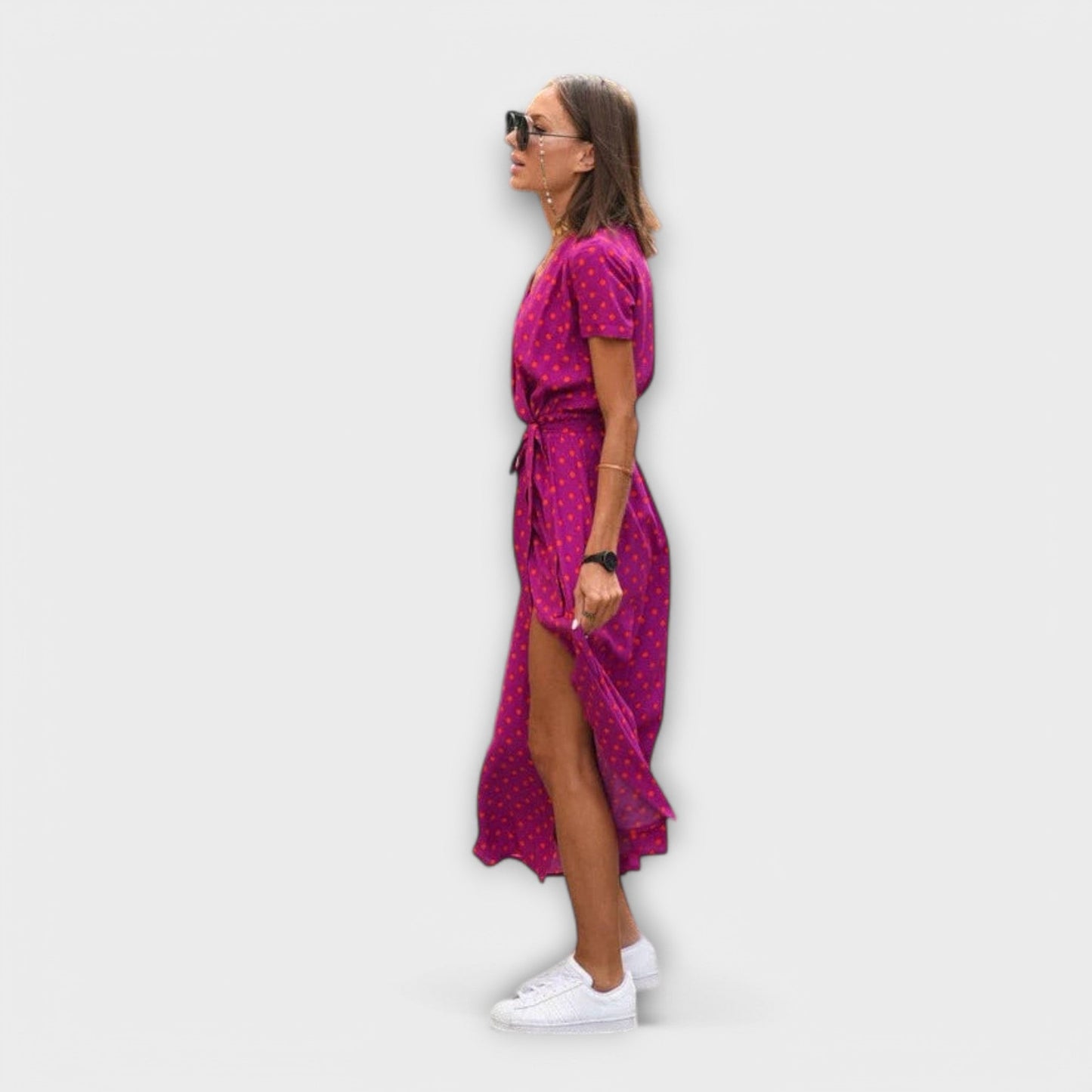 Mariz women's pleated midi dress in pink dot print, side view showing front slit