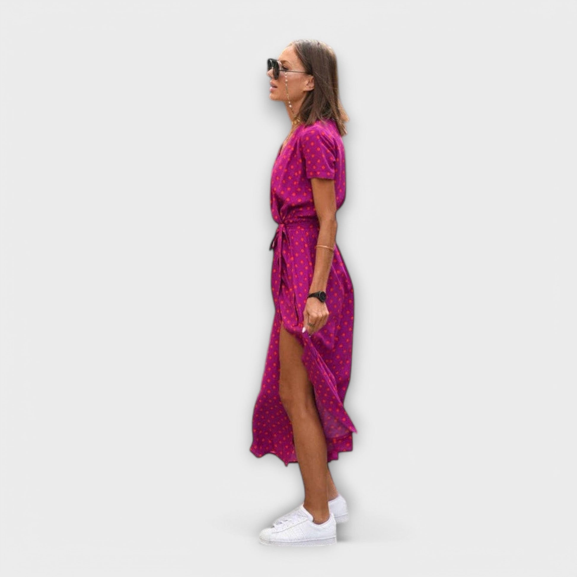 Mariz women's pleated midi dress in pink dot print, side view showing front slit