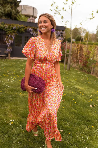 Lotte orange floral maxi dress with flutter sleeves, walking front view