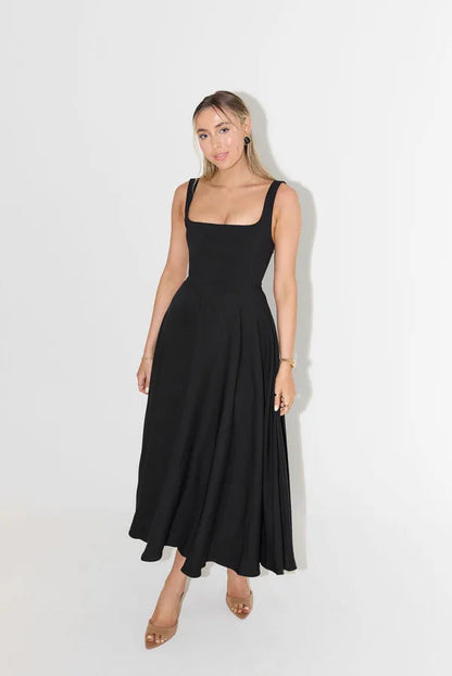 Edmee black sleeveless A-line maxi dress, front view on white backdrop