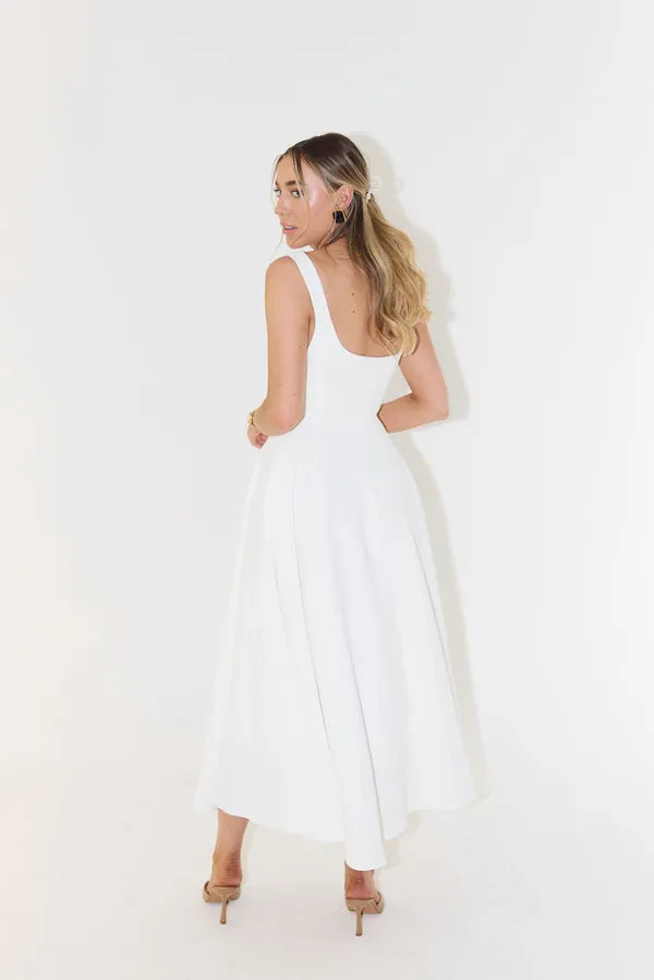 Back view of the white Edmee sleeveless A-line maxi dress on the model