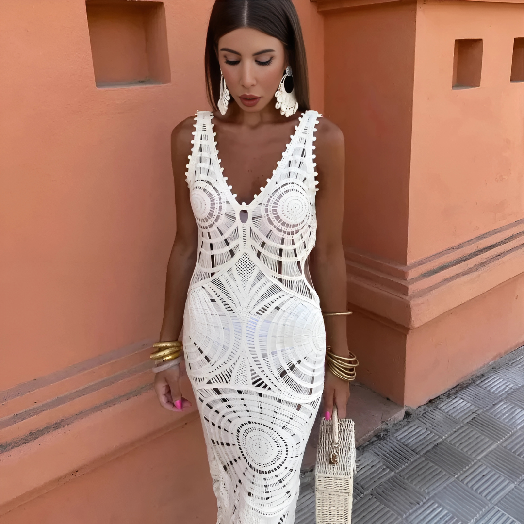 White Kalliope lace maxi dress front detail showing the deep V neckline and pom trim