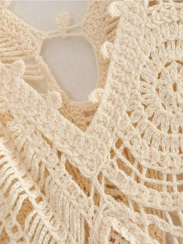 Macro close-up of the ivory crochet lace fabric of the Kalliope maxi dress