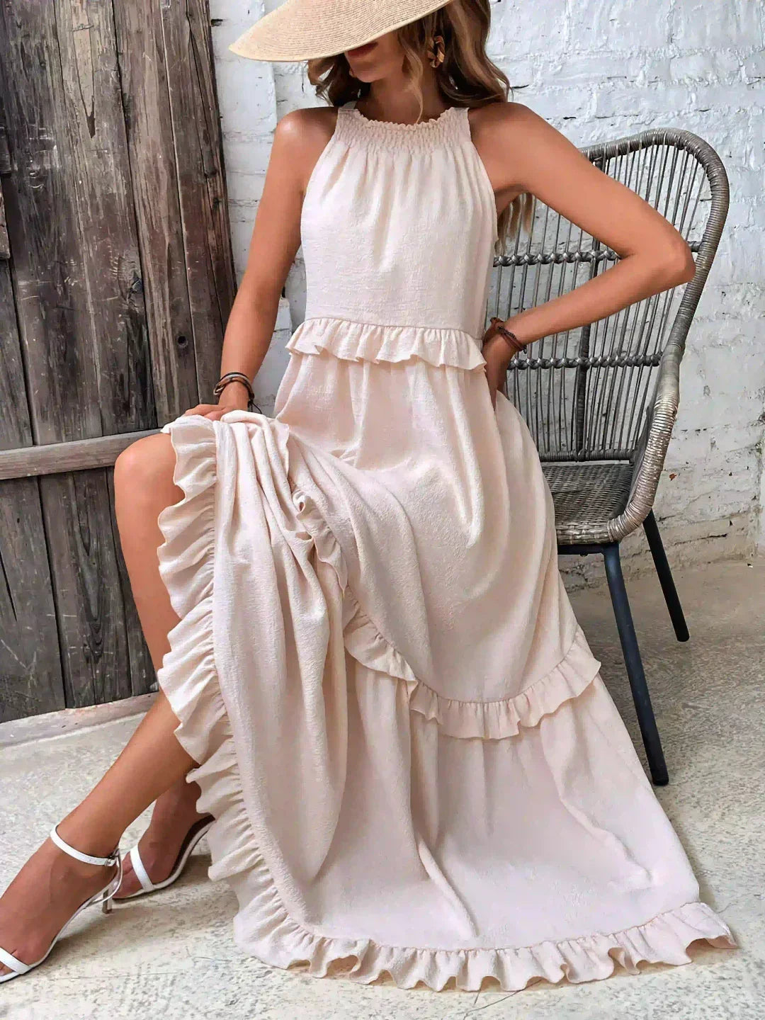 Beige Kiersten maxi dress worn with a straw hat, front view showing the ruffled tiers