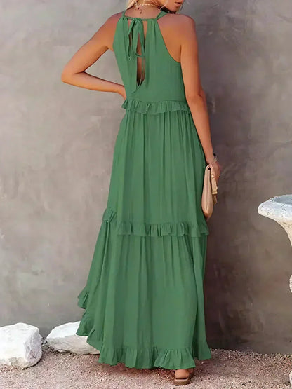 Back view of the green Kiersten sleeveless tiered maxi dress with tie closure