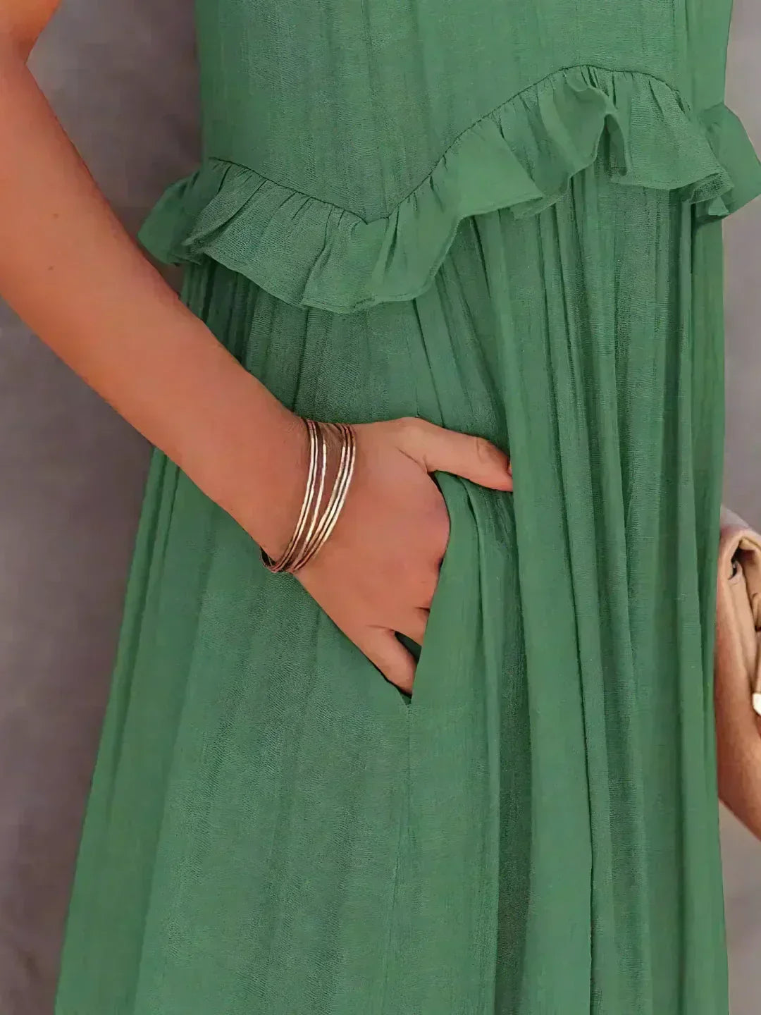 Close-up of the green Kiersten maxi dress side pocket and ruffle seam detail