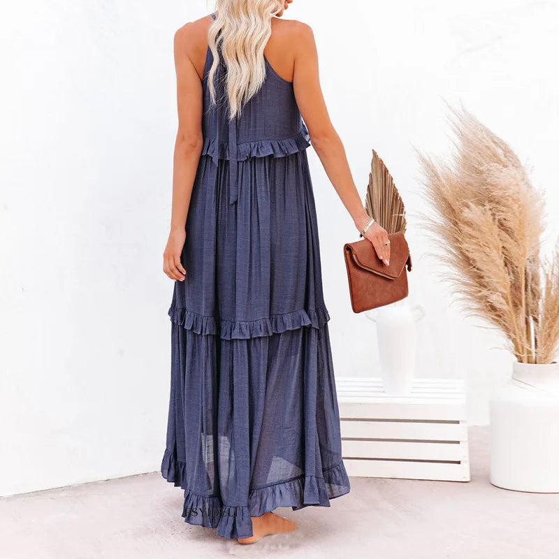 Marine blue Kiersten sleeveless maxi dress seen from behind with a leather clutch