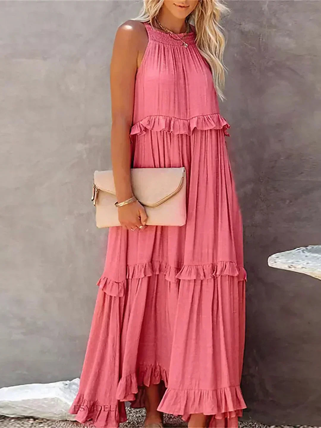 Pink Kiersten sleeveless maxi dress front view styled with a blush clutch