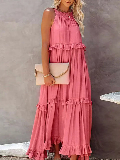 Pink Kiersten sleeveless maxi dress front view styled with a blush clutch