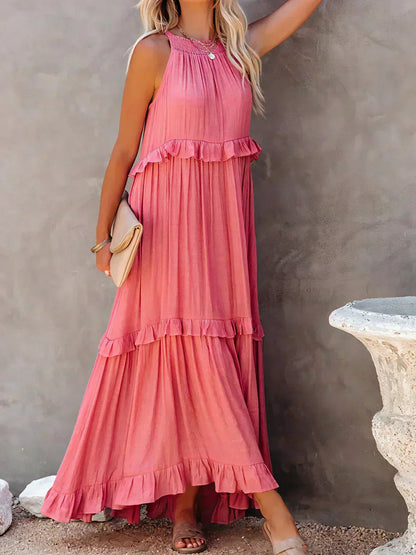 Full length front view of the pink Kiersten tiered maxi dress with clutch bag