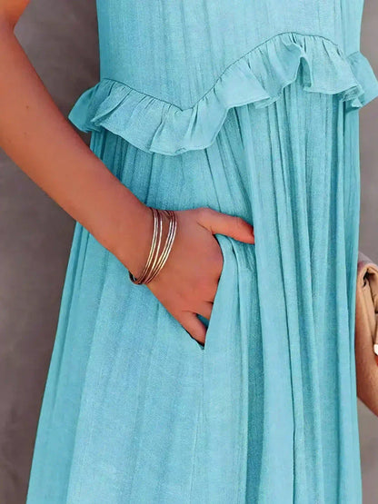 Close-up of the sky blue Kiersten maxi dress pocket and ruffle waist seam
