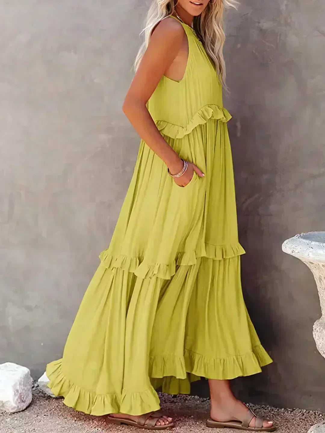 Side view of the yellow Kiersten maxi dress with its sweeping tiered hem