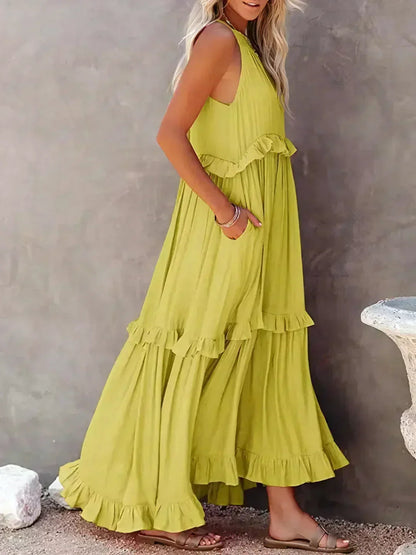 Side view of the yellow Kiersten maxi dress with its sweeping tiered hem