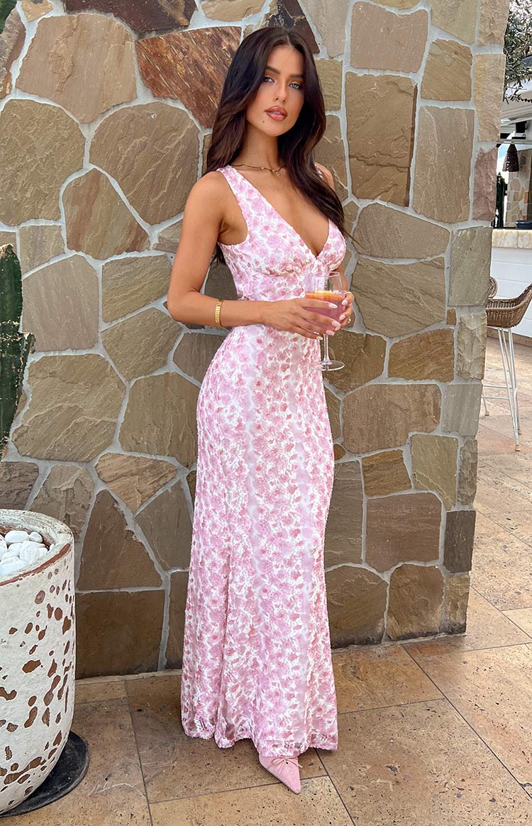 Side profile of the pink Florine floral open back maxi dress on model