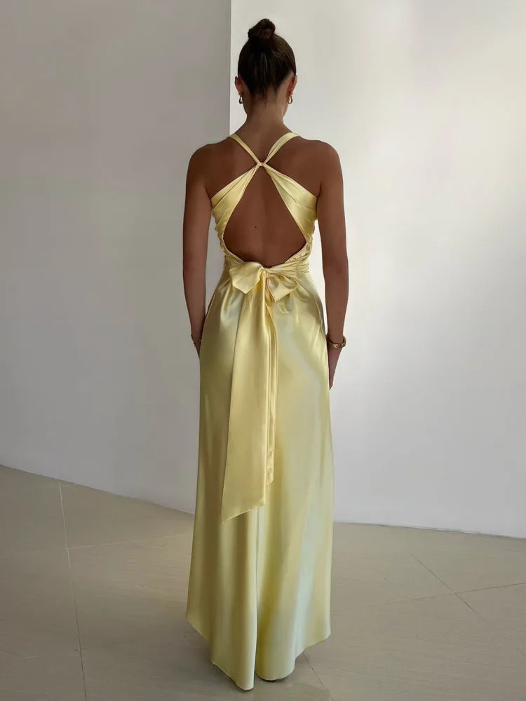 Back view of the yellow Joline maxi dress showing the open back and tie sash