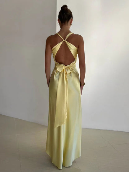 Back view of the yellow Joline maxi dress showing the open back and tie sash