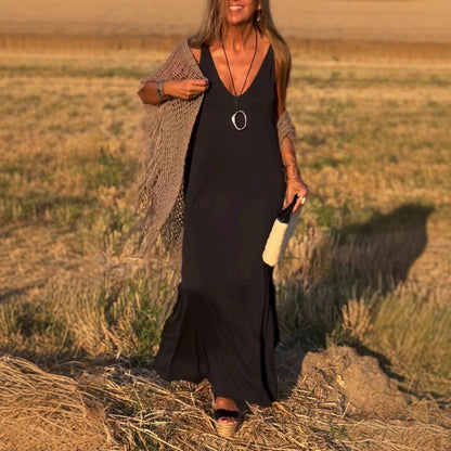 Kalina black V-neck side slit maxi dress styled with a knit cardigan, front view