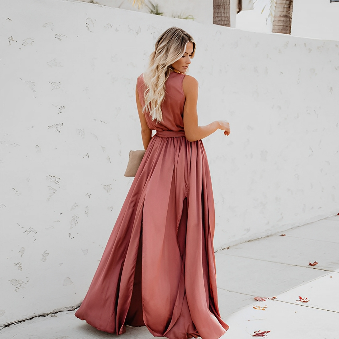 Back view of the pink Chloe sleeveless wrap maxi dress with flowing skirt