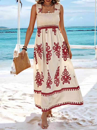 Lilias women's smocked printed maxi dress with red baroque motifs, beach front view