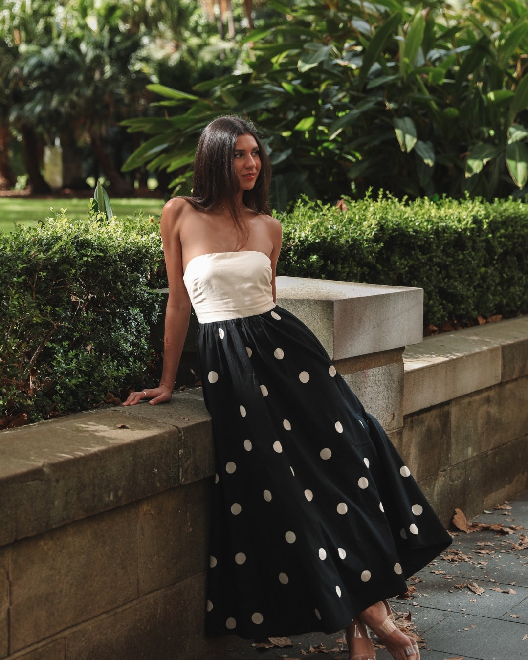 Black Nives strapless polka dot maxi dress with ivory bodice, front view outdoors