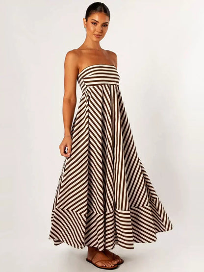 Angled view of the Orsolya strapless striped maxi dress showing the skirt volume