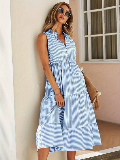 Violeta women's striped flowy summer midi dress in blue stripes, side view on model