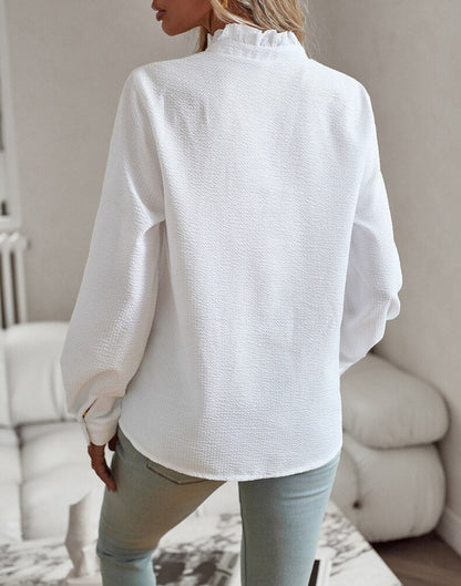 White Elettra striped ruffle long sleeve blouse, back view showing the curved hem