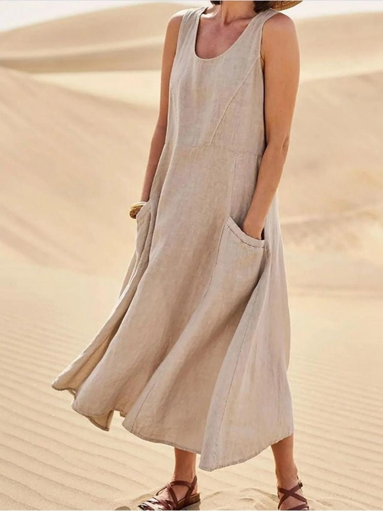 Perpetua women's summer midi dress in khaki linen, front view on model in the desert
