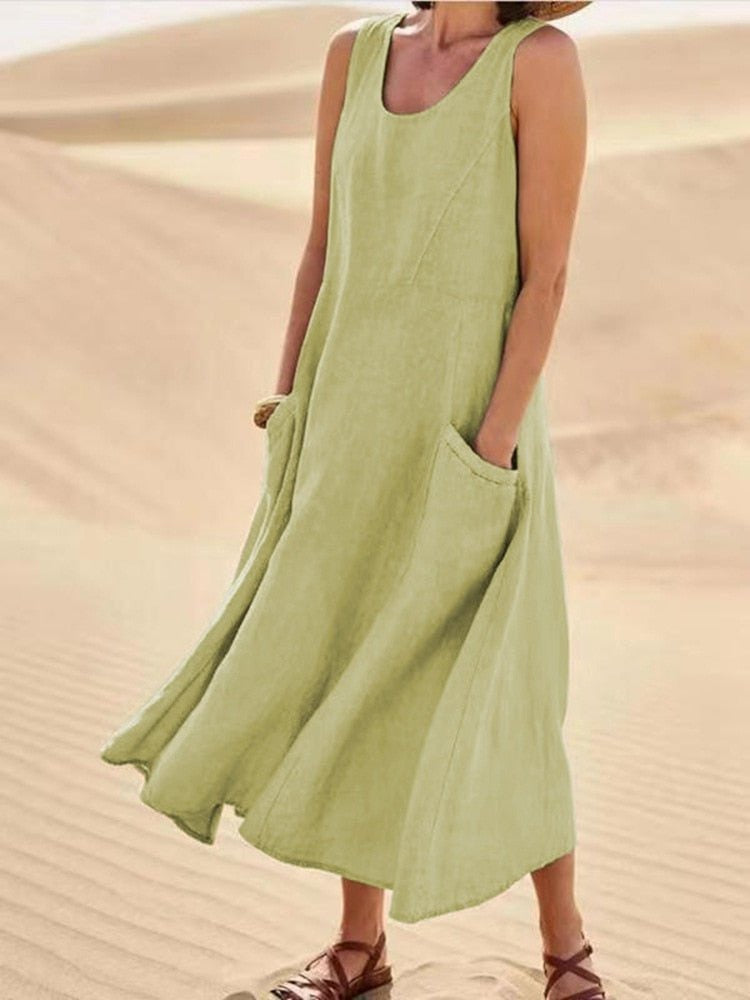 Perpetua women's summer midi dress in light olive green linen, front view outdoors