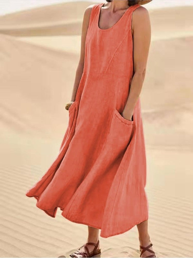 Perpetua women's summer midi dress in orange linen, front view on model in the desert