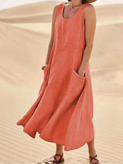 Perpetua women's summer midi dress in orange linen, front view on model in the desert