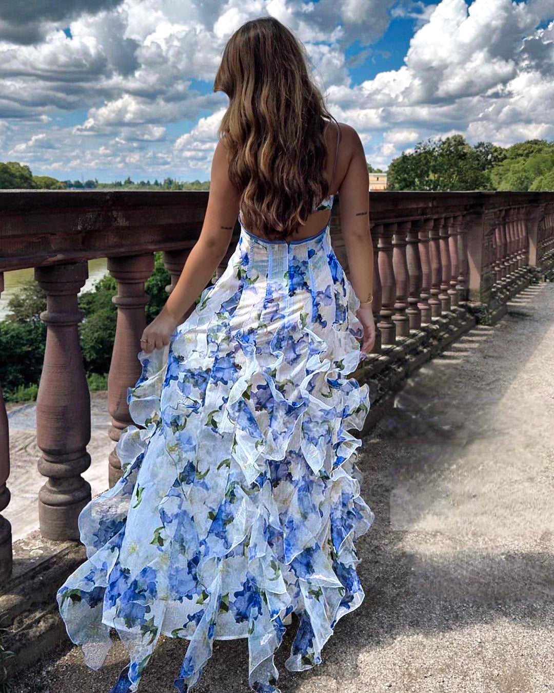 Back view of the Evadne white floral ruffled maxi dress with open back detail