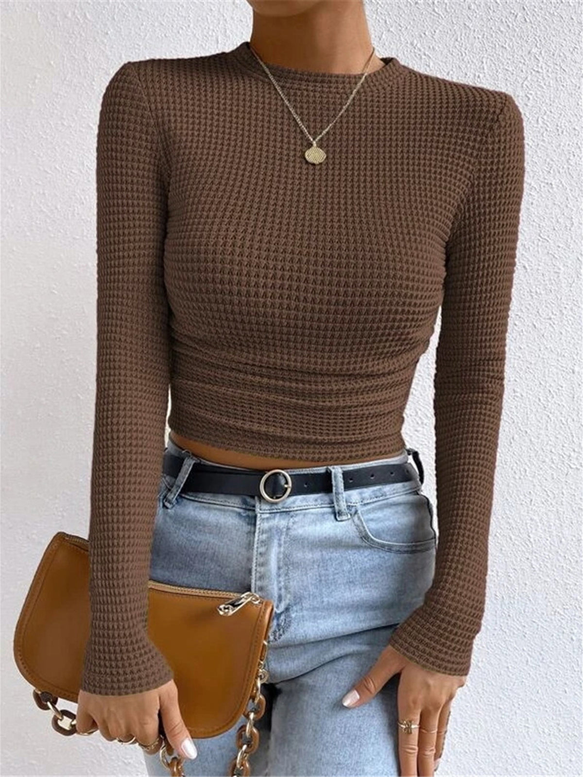 Danae Women's Textured Long Sleeve Crop Top in brown, front view with shoulder bag