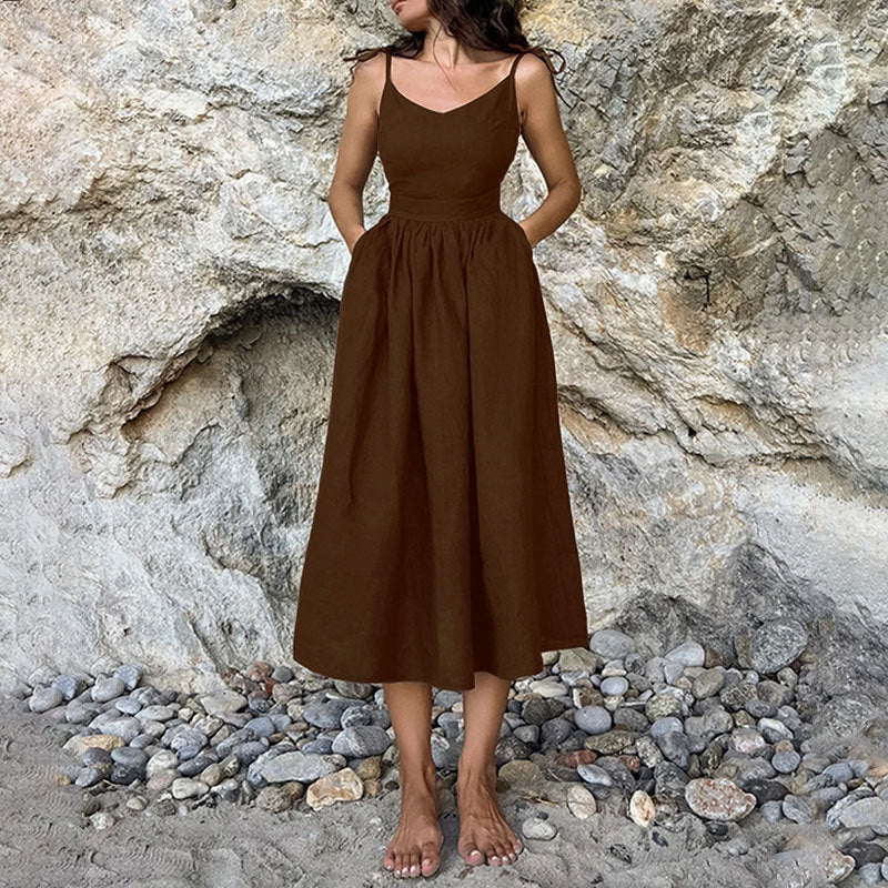 Dark brown Eudora tie-strap linen maxi dress, front view against a rocky backdrop