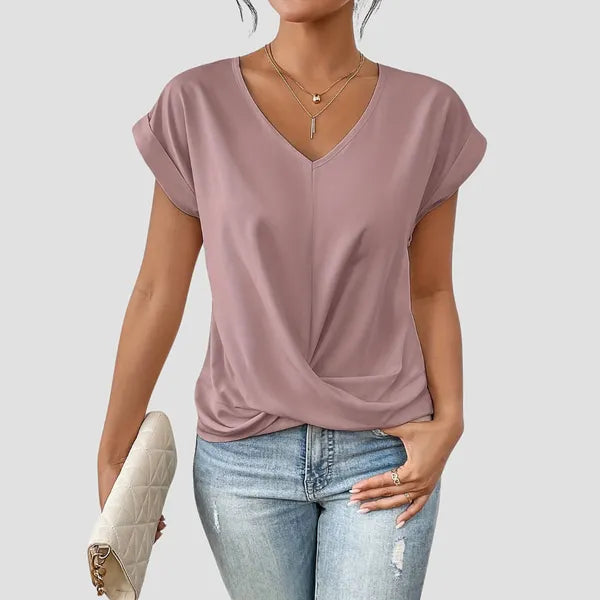 Sancia women's twist front short sleeve blouse in pink, front view with jeans