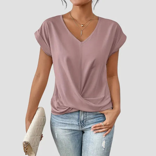 Sancia women's twist front short sleeve blouse in pink, front view with jeans
