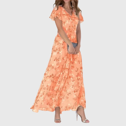 Millicent women's wedding guest floral maxi dress in orange, front view on model