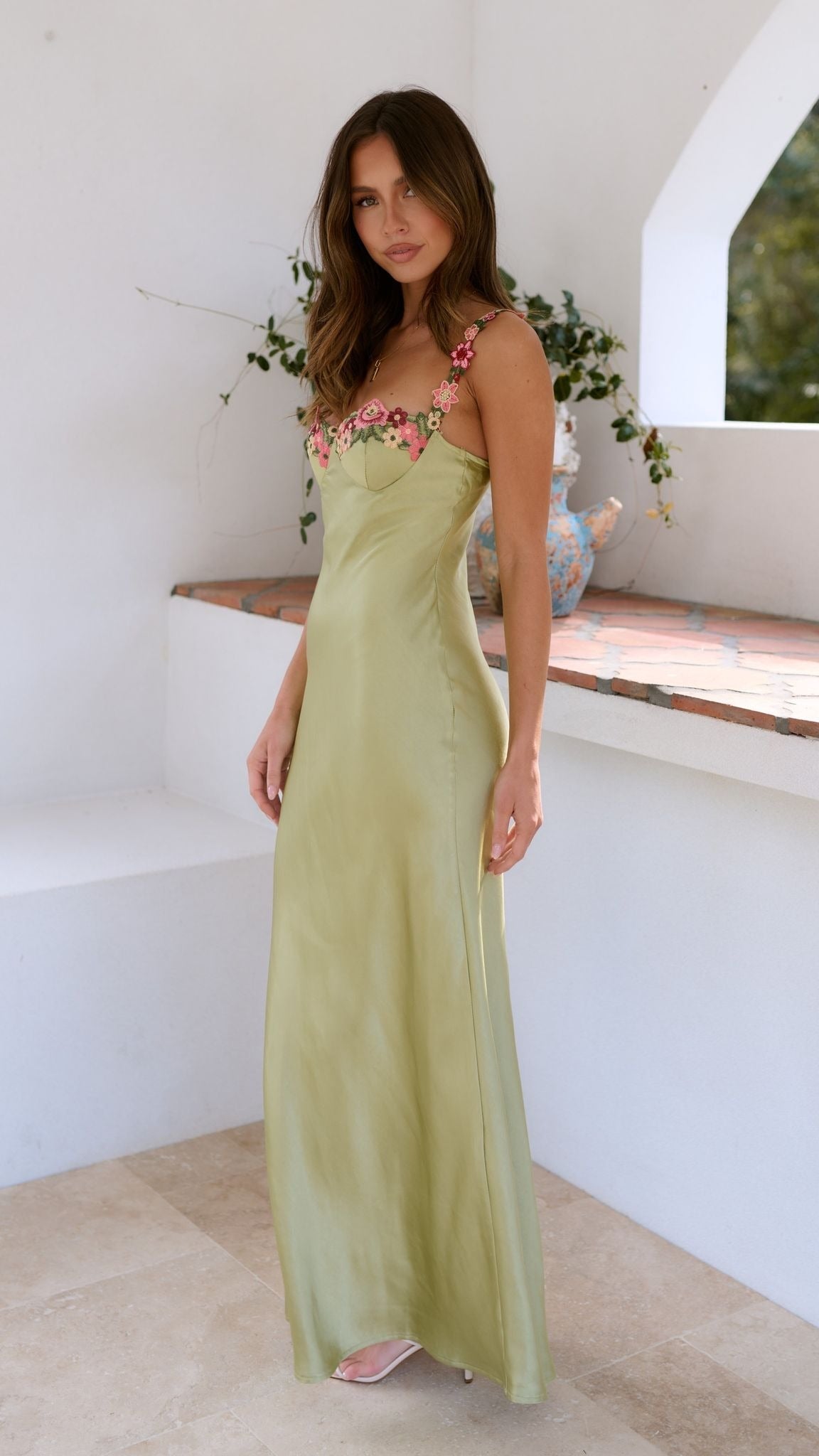 Lucienne lime satin slip maxi dress for women, side view against a white wall