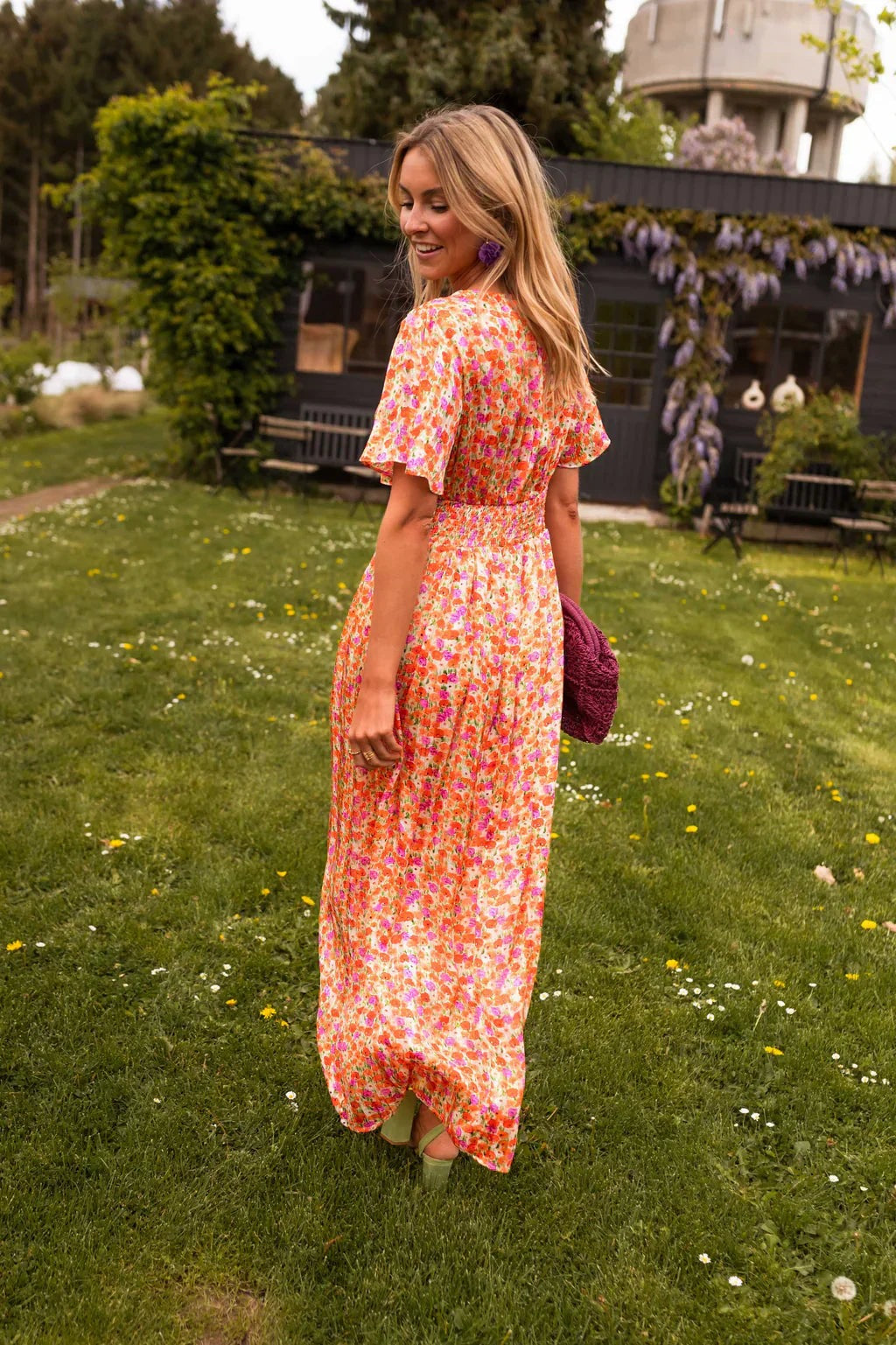 Back view of the Honoria women's orange floral wrap summer maxi dress