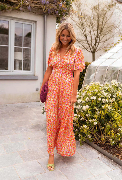 Orange Honoria women's floral wrap summer maxi dress, front styling shot outdoors