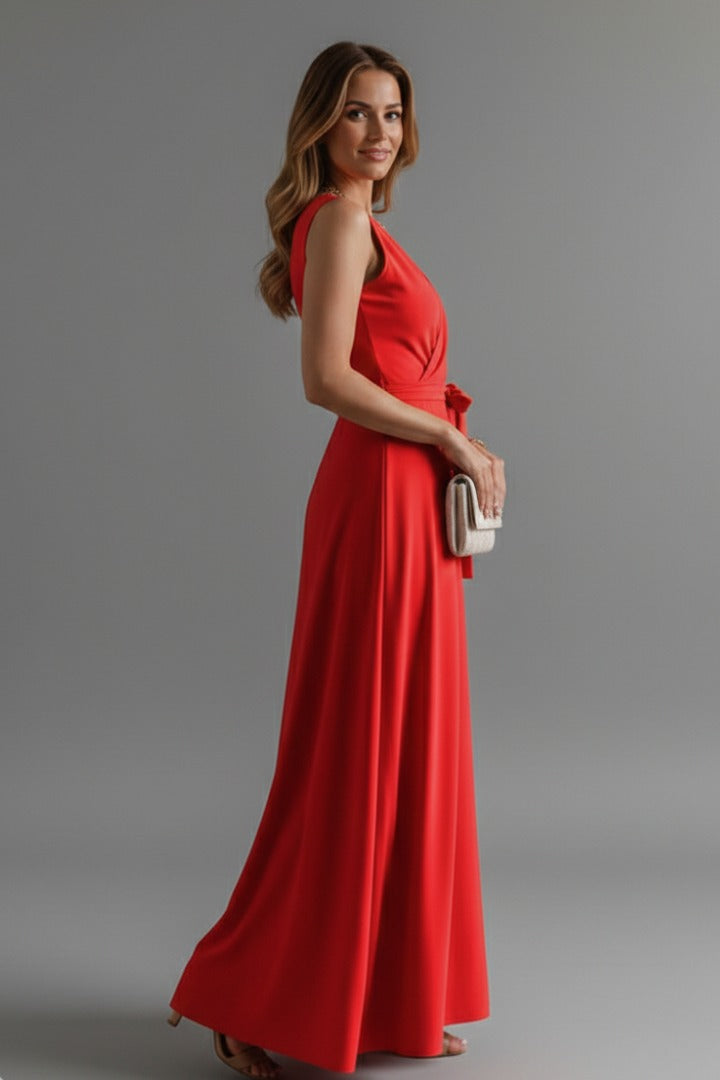 Matilda women's red satin wrap maxi dress, side profile view with clutch bag